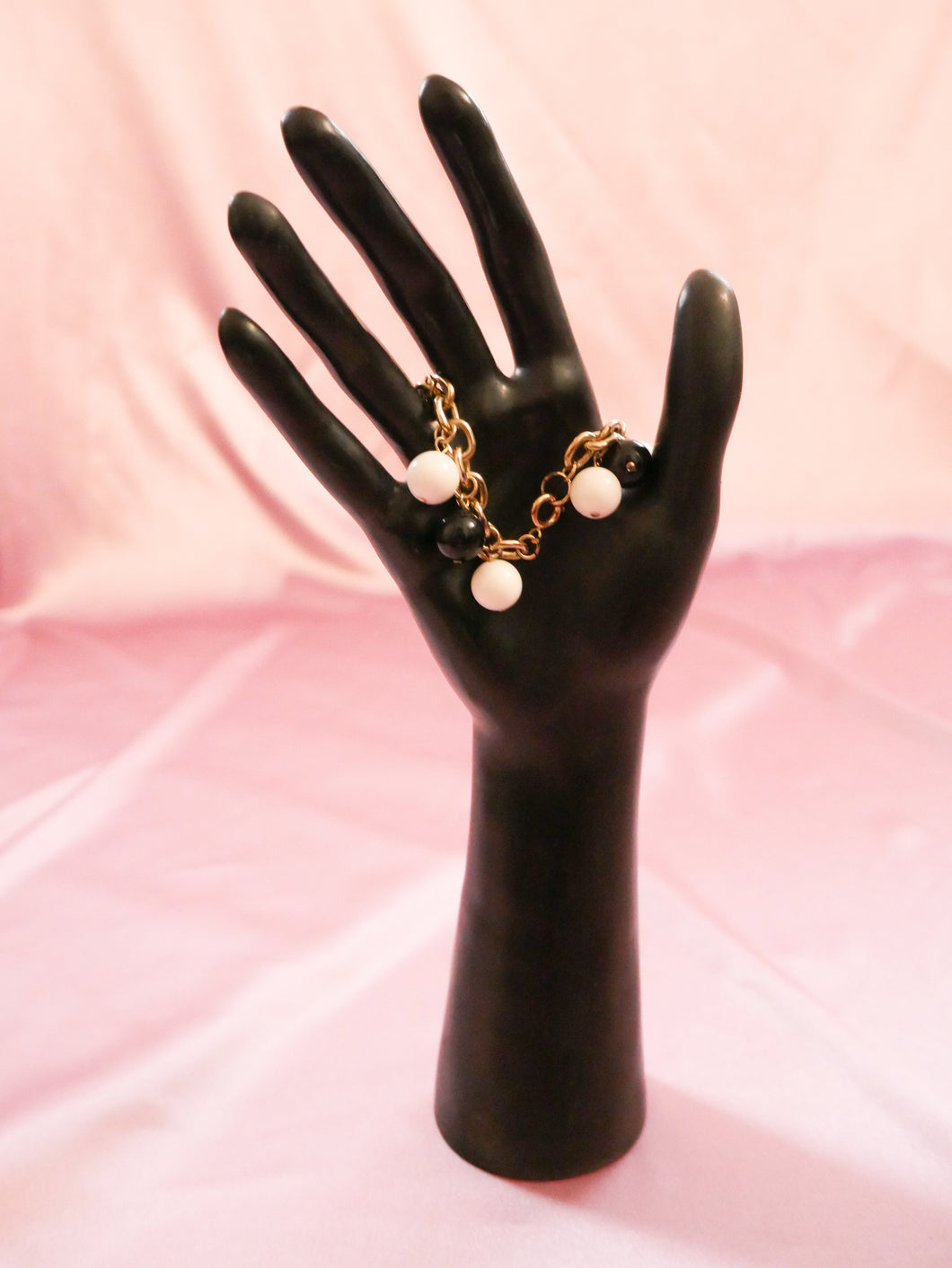 vintage charm bracelet women's jewelry on black mannequin hand