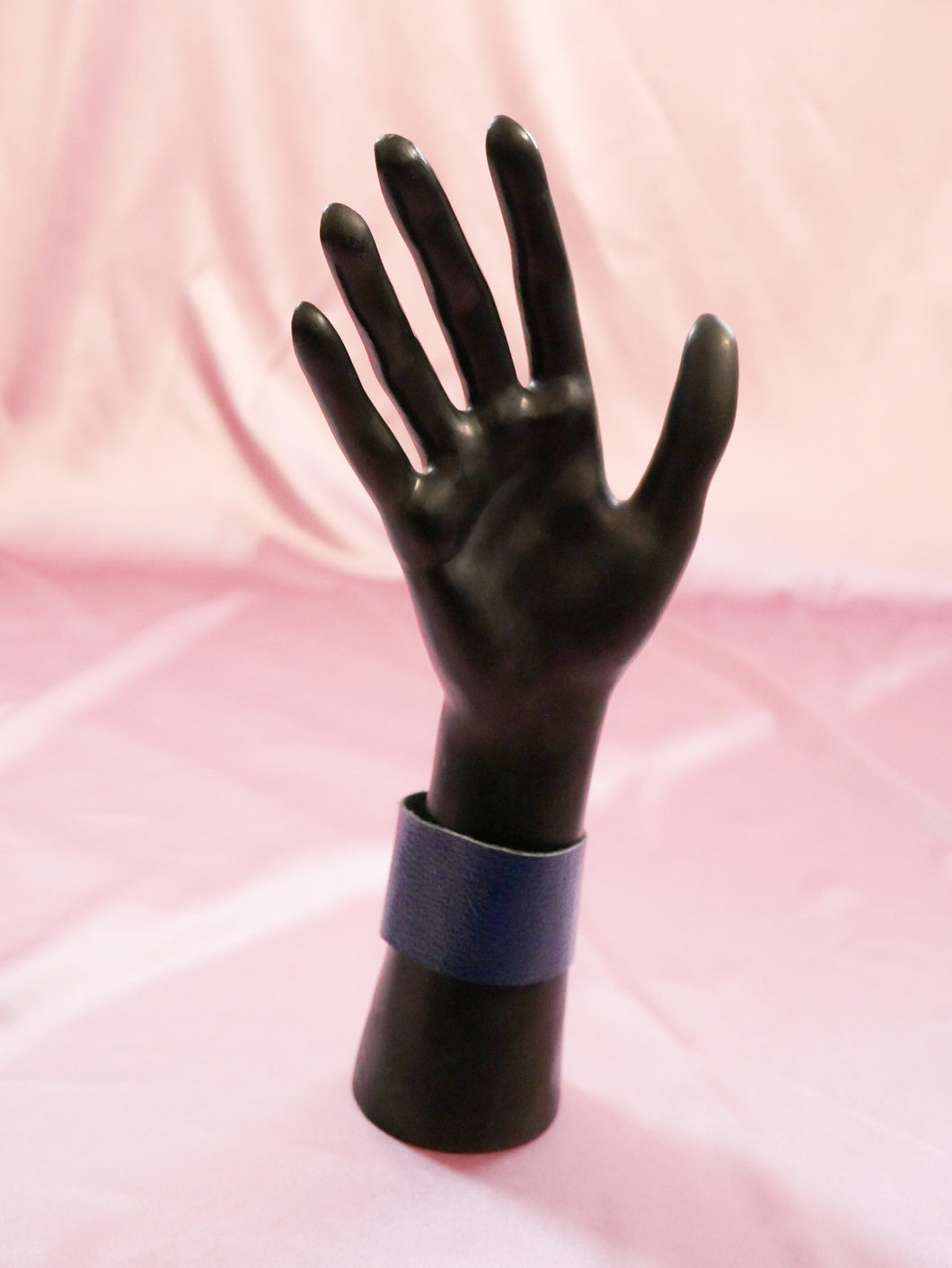blue faux croc wrap bracelet women's jewelry on a black mannequin hand
