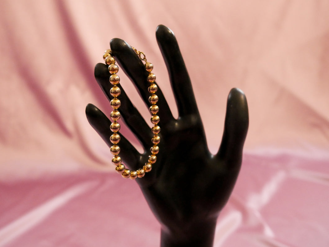 vintage gold brass beaded bracelet women's accessory on black mannequin