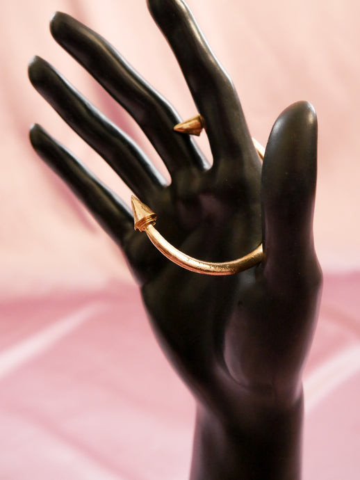 gold spike bracelet women's accessory on black mannequin hand