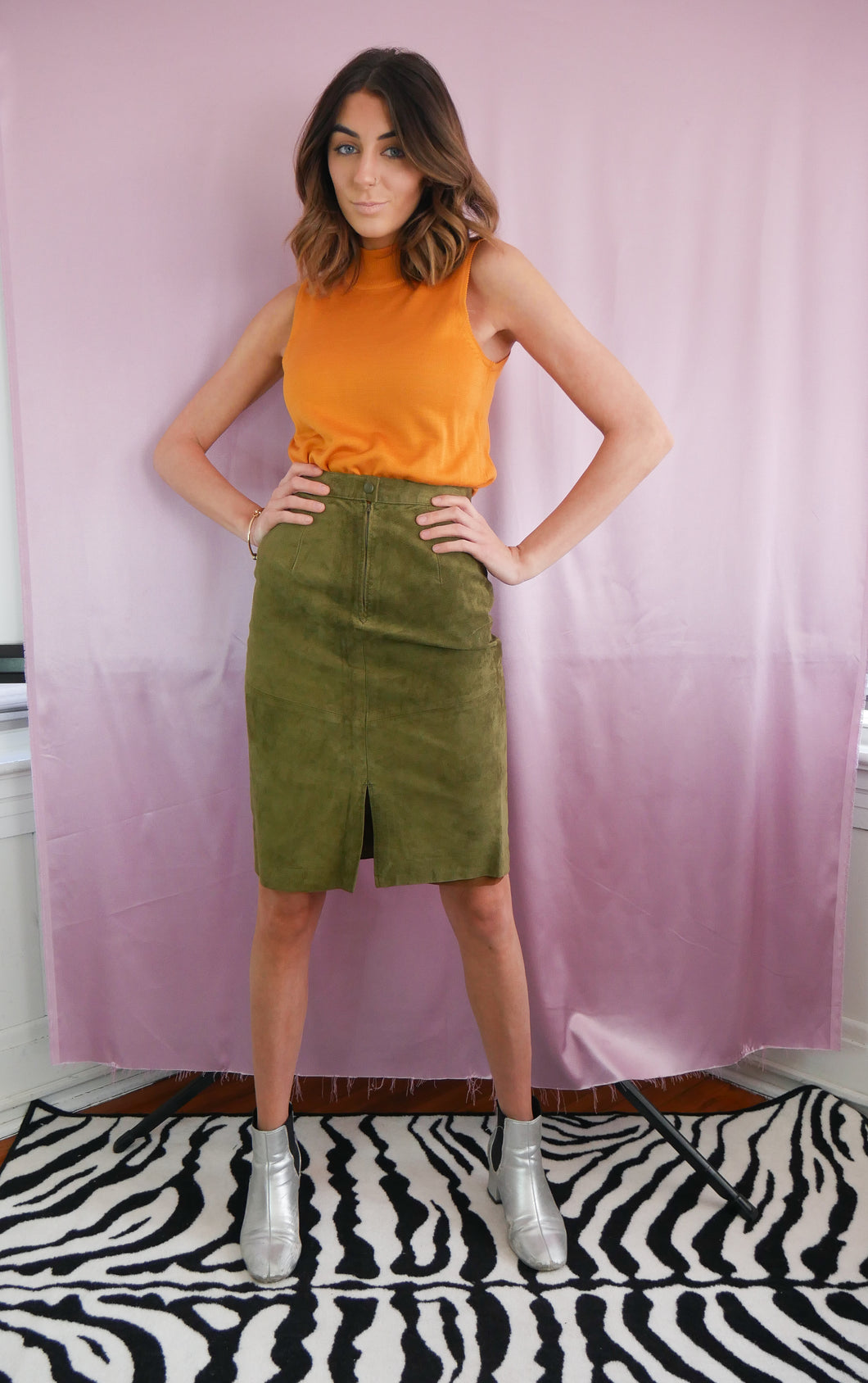 woman wearing vintage 1980's green suede pencil skirt and vintage orange turtleneck women's clothing