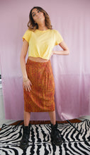 Load image into Gallery viewer, woman wearing 1980&#39;s orange and green silk high waisted skirt, doc martens and yellow tshirt women&#39;s clothing
