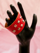 Load image into Gallery viewer, red leather wrap cuff with silver studs on a black mannequin hand women&#39;s jewelry
