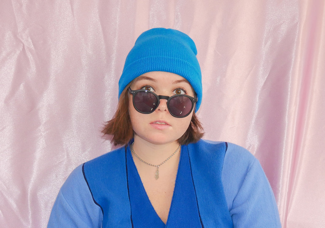 new black round sunglasses blue hat blue sweater accessories